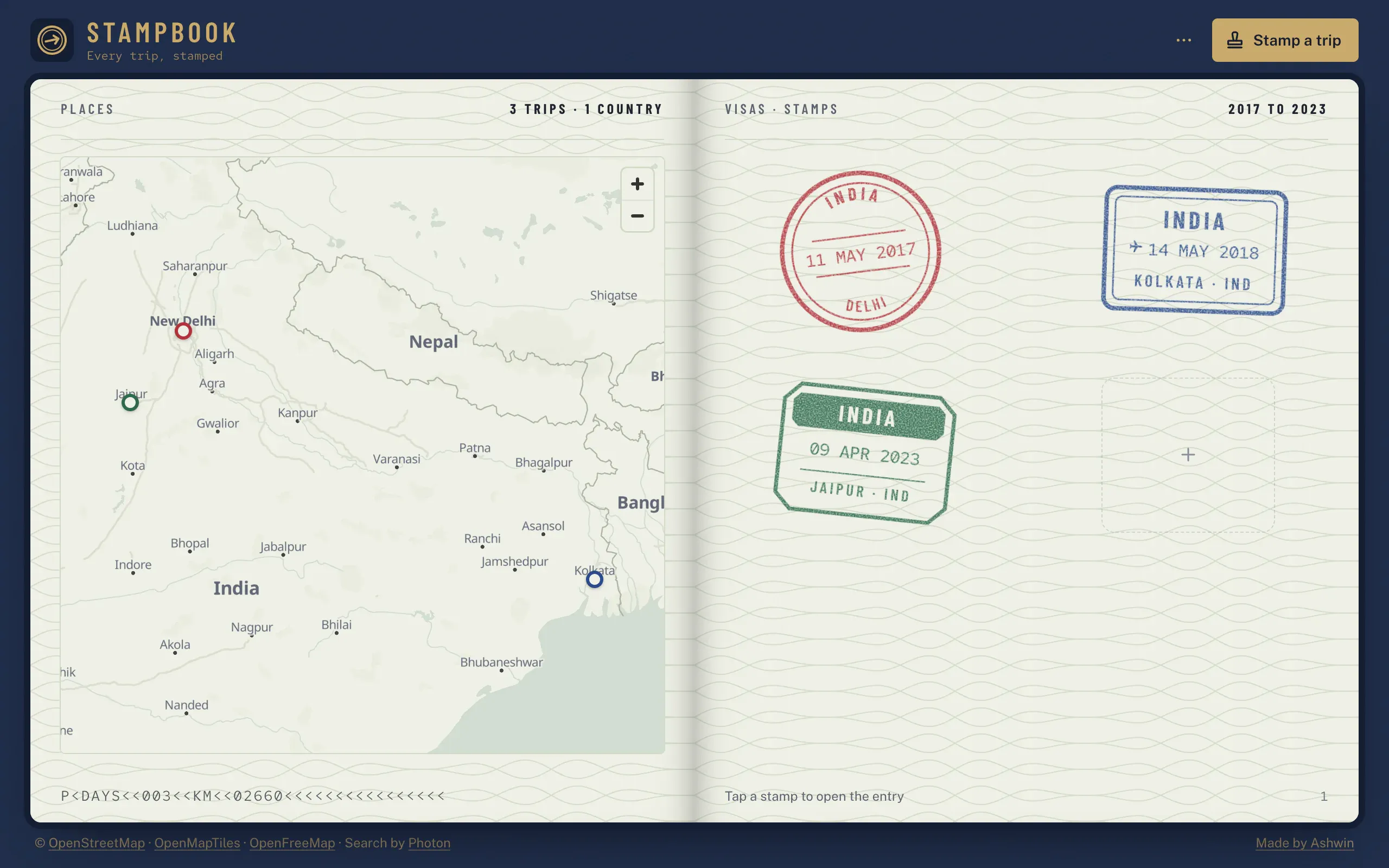 Stampbook open on a desktop: a map of north India with pins for Delhi, Jaipur and Kolkata on the left page, and a round red, a boxed blue and an octagonal green stamp on the visa page on the right