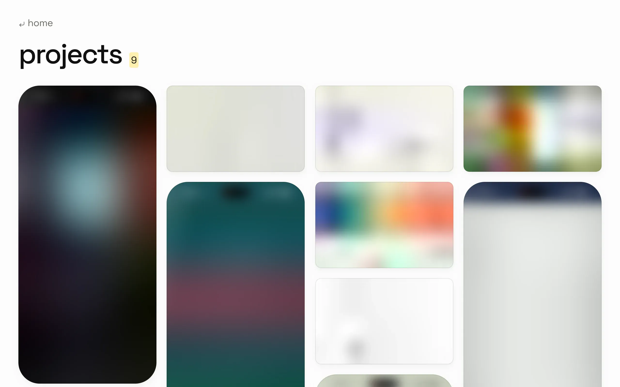 the projects page while its media is still loading: every card is a soft blurred version of its picture in its final shape, the phone recordings as tall blurred rectangles