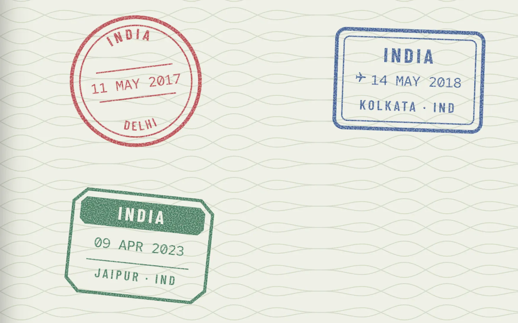 the three sample stamps up close: a round red Delhi stamp, a boxed blue Kolkata stamp and an octagonal green Jaipur stamp with a filled band, each tilted a little differently, their ink worn and speckled